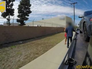 Curly hair teen blows tow truck driver